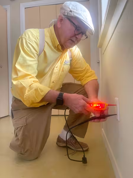 Bud testing an electrical outlet